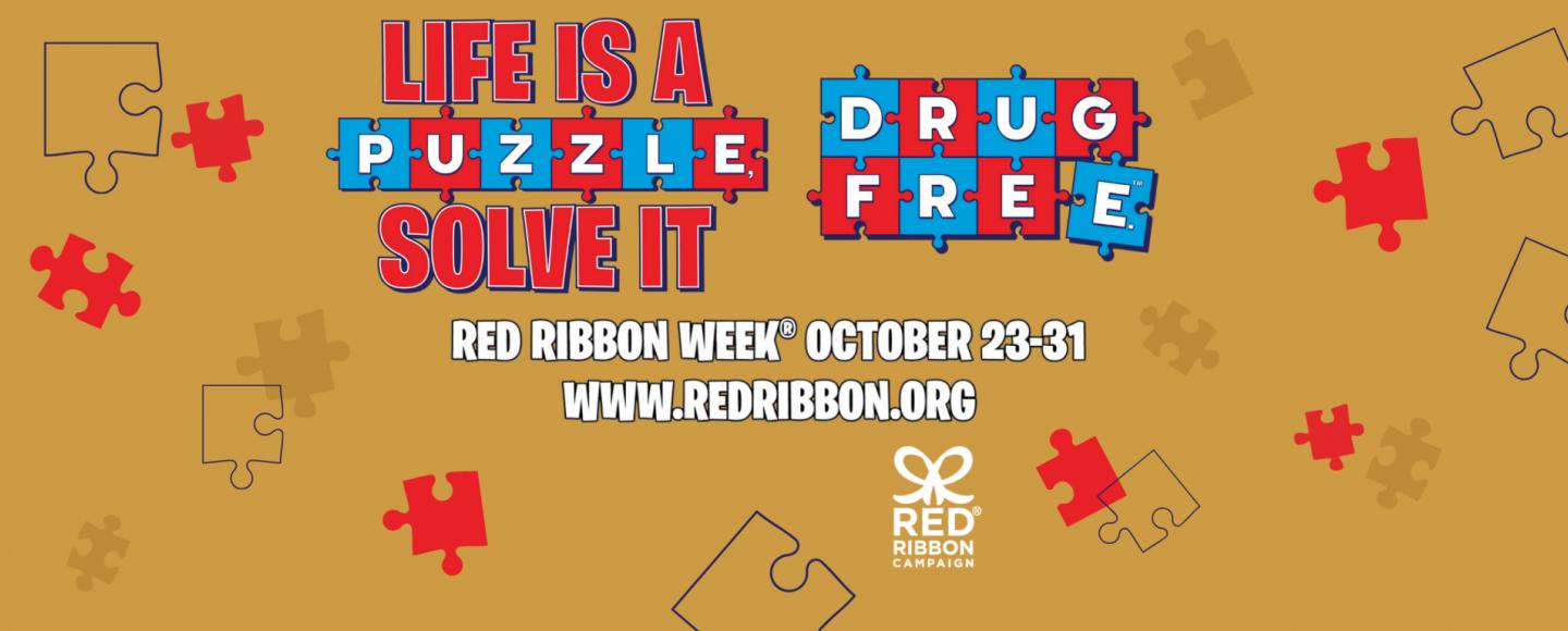 Banner in mustard yellow and words in blue and red puzzle pieces: Life is a puzzle, solve it drug free. Red Ribbon Week, October 23-31, redribbon.org